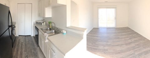 natural sunlight, bright white clean cabinets, wood flooring, premium countertops and appliances at regency apartments in Bettendorf Iowa
